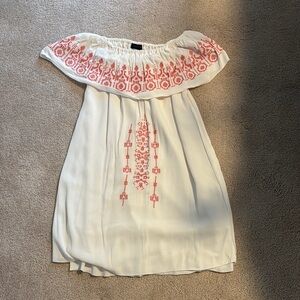White Off-Shoulder Dress with red Embroidery. Fabric is flowy and lined.